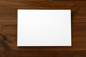 Blank paper brochure on wooden table, top view. Mockup for design