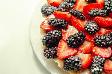 Butter enriched shortcrust pastry topped strawberries and blackberries, seasonal cake with colorful...