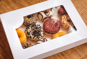 Assortment of donuts of different flavors in a box. 
