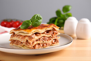 Delicious cooked lasagna served on wooden table