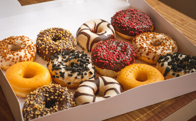 Assortment of donuts of different flavors in a box. 
