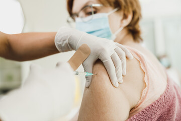 Obraz na płótnie Canvas Senior Woman Vaccination Due To Covid-19 Pandemic