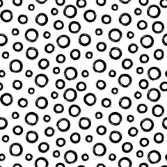Black and white seamless pattern with rings in brush stroke technique. Abstract background with hand painted circles.
