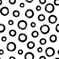 Black and white seamless pattern with rings in brush stroke technique. Abstract background with hand painted circles.