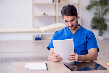 Young male doctor working in the clinic