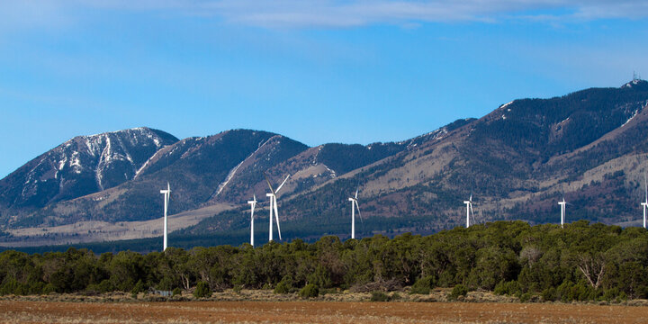 Wind farm against a scenic background of mountains in Utah