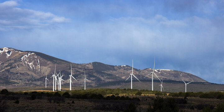 Wind farm against a scenic background of mountains in Utah