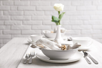 Beautiful table setting with cutlery and napkin in restaurant. Space for text