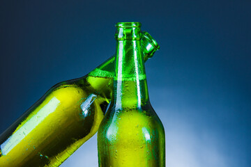 green beer bottle cheer  on blue background