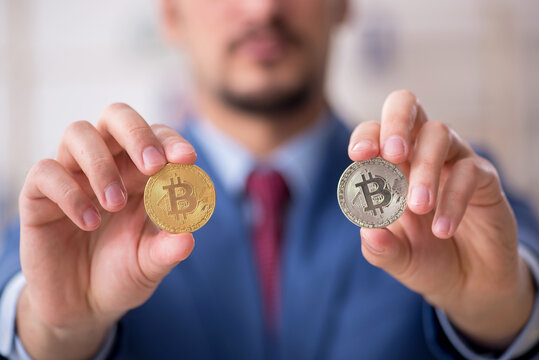 Young man earning money via Internet in cryptocurrency concept