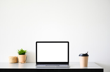 Laptop computer with blank screen in office