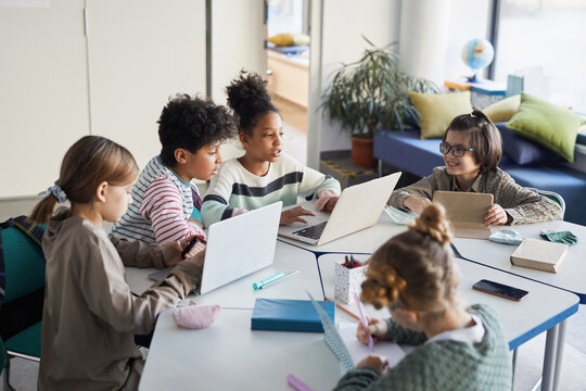 High Angle View At Group Of Children At Table In Modern School, Copy Space