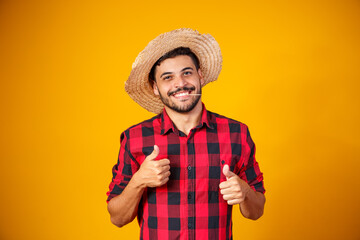 man dressed in junina party outfit with thumb up making ok sign - obrazy, fototapety, plakaty