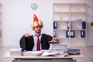 Funny young male employee magician and too much work in the office