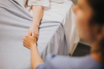 Obraz na płótnie Canvas Nurse holding her patients hand