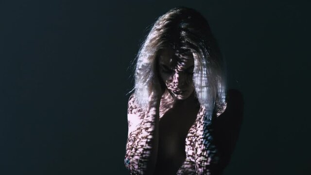 Depressed woman. Silhouette portrait. Mental error. Psychology disorder. Cataleptic naked lady grasping head double exposure numbers pixels glitch noise dark light background copy space.