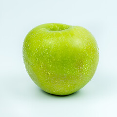 Perfect fresh green apple with water drops isolated on white background.