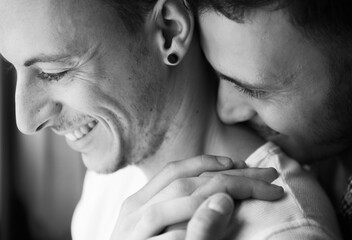 Sweet gay male couple close together