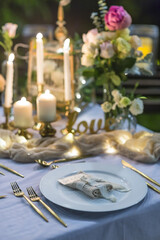Romantic Wedding Table Top Layout Table Spread no people tropical location with gold cutlery at night evening event