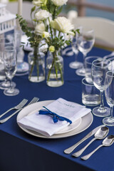 Blue and Silver Romantic Wedding Table Top Layout Table Spread no people no human tropical location with swimming pool and sea and clouds in the background 