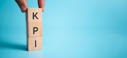 Banner KPI concept with wooden block on blue background. Key Performance Indicator using Business...