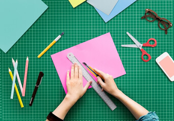 Closup aerial view of hands cutting paper