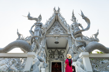 Sisaket, Thailand - April 6, 2021: Female tourist visits Thai temple, Sisaket, Thailand.