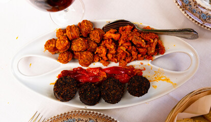 Tasty hot spanish snack from blood sausage with chorizo, picadillo and roasted pepper