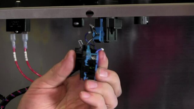 Removing plug on paint mixer with screw driver close up