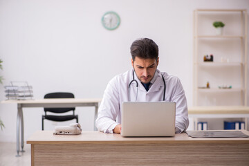 Young male doctor in telemedicine concept