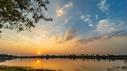Sunlight with dramatic sky. sunset on dark background.Vivid orange cloud sky over the river.