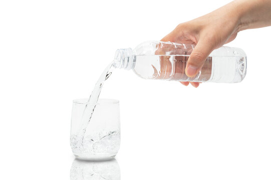 Man's hand pouring water into a glass. - Powered by Adobe