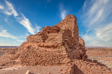 Wupatki National Monument located in north-central Arizona, near Flagstaff. Native American archaeological hilltop dwelling sites made from red stone built by ancient Sinagua pueblo people, blue sky