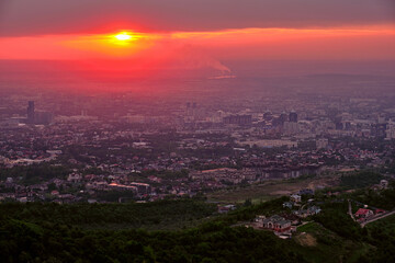 Magical atmosphere of the sunset over the evening city; Almaty town in Kazakhstan