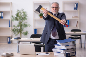 Old male employee unhappy with excessive work in the office