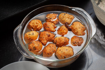 Plain dry dahi badhe for preparation of chaat, shocking in water after frying