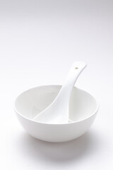 An empty ceramic white bowl with soup spoon for mockup. over white background