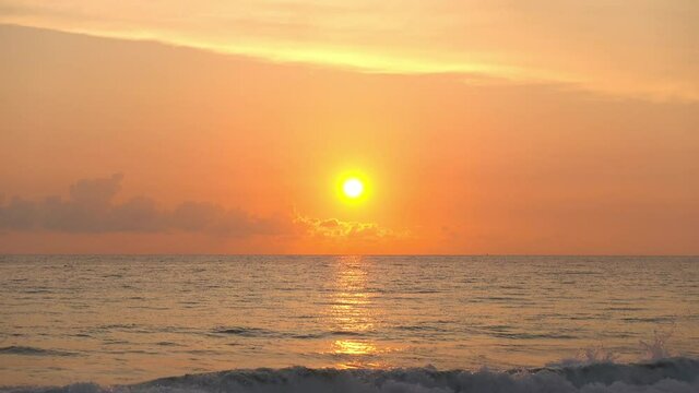 Professional 4K Video. Scene of Sunset on tropical beach sea. No people at beach. Phuket Thailand beautiful tropical beach with a sunset sky. Beautiful Phuket beach in Andaman sea sunset.