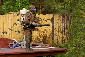 a man treats a private territory from ticks. acaricide treatment.