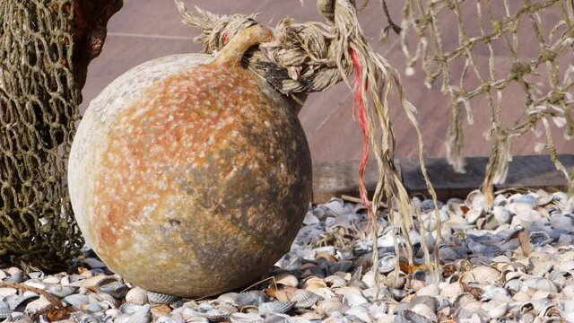 A sphere at a port and ropes hanging in the wind