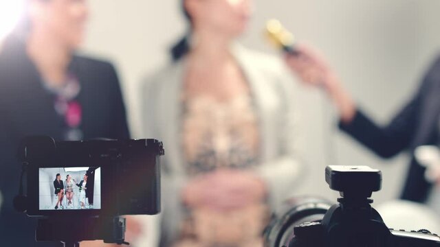 A behind the scenes look at an LGBTQ talk show - focus on the cameras in the foreground with blurred background