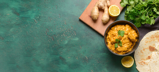 Bowl of tasty chicken tikka masala on color background with space for text