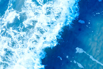 Deep blue and rough sea with lot of sea spray.Blue background.Soft focus,blurred image.
