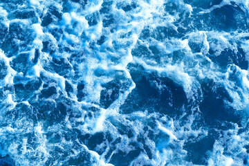 Fototapeta na wymiar Deep blue and rough sea with lot of sea spray.Blue background.Soft focus,blurred image.