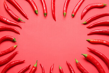 Composition with hot chili pepper on color background