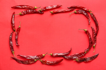 Frame made of hot chili peppers on color background