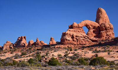 the eroded rock formation of  turret arch in arches national park on a sunny day near moab, utah 