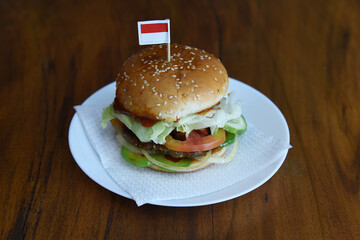 hamburger on a plate with indonesian's flag on top