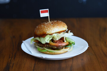 hamburger on a plate with indonesian's flag on top