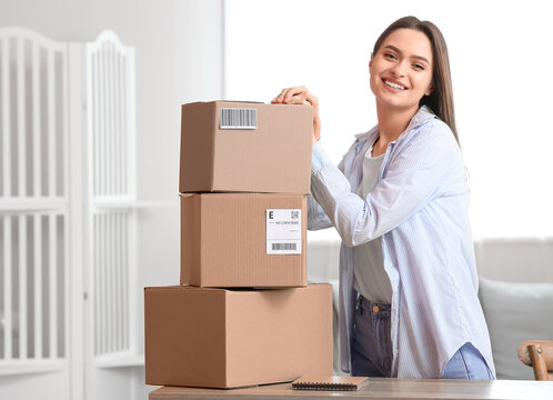 Young woman with parcel boxes at home
